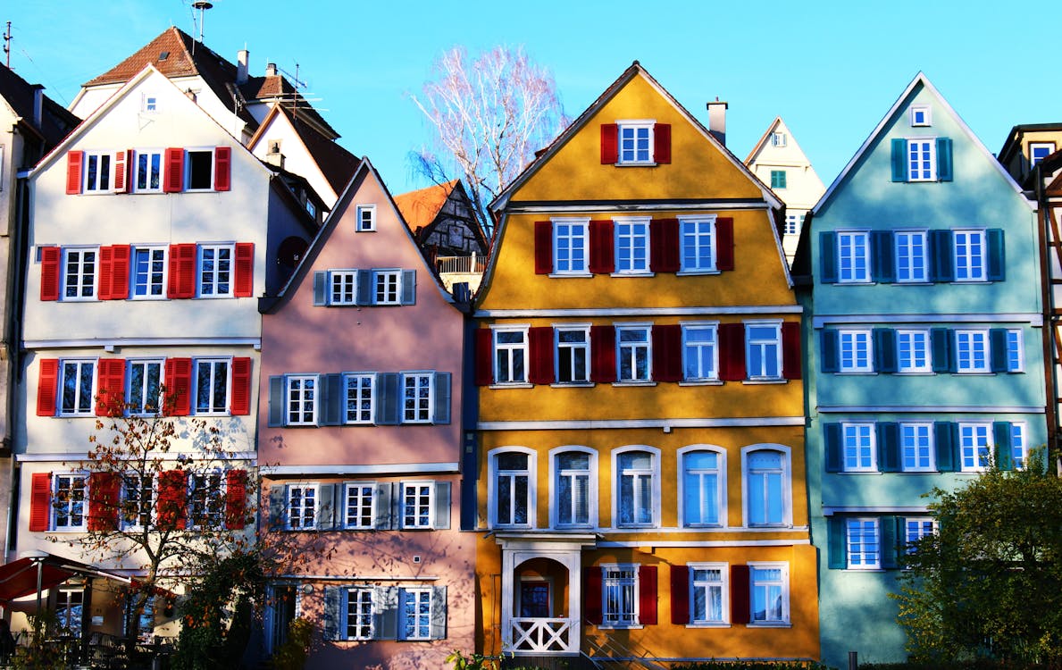 Free White, Pink, Yellow, and Teal Painted Houses Stock Photo