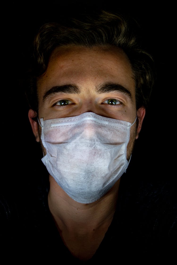 A Man Wearing A Disposable Face Mask