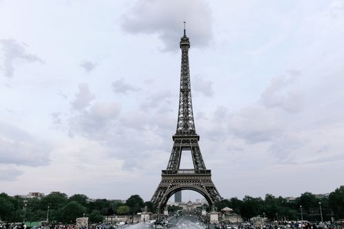 Free Iconic view of the Eiffel Tower under a cloudy sky in Paris, France. Stock Photo