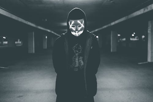 Free Man wearing hood and mask with neon lights Stock Photo