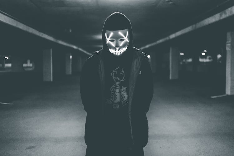 Man Wearing Hood And Mask With Neon Lights