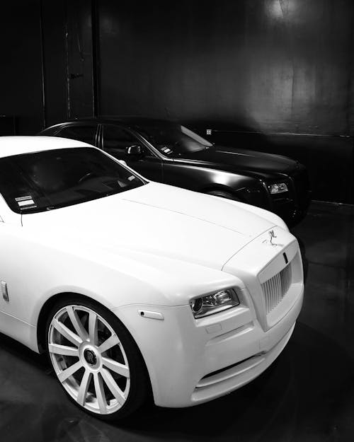 High angle of modern stylish black and white vehicles parked in black garage