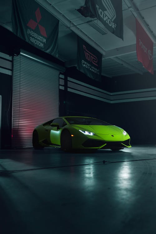Free A Green Sports Car Parked on Concrete Floor Stock Photo