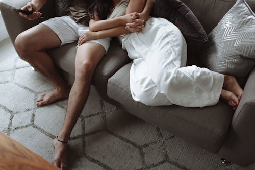 Couple on a Sofa Holding Hands