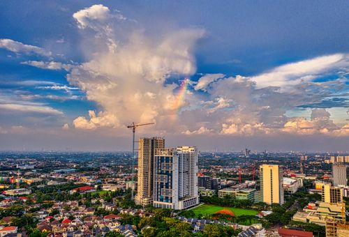 Free Aerial view of Banten, Indonesia featuring urban skyline and a vibrant rainbow. Stock Photo