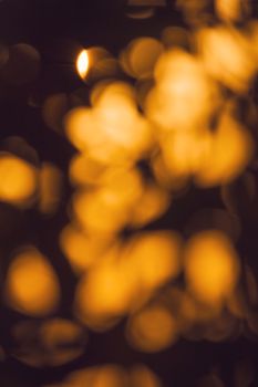 Abstract warm golden bokeh pattern with blurred lights creating a cozy ambiance.