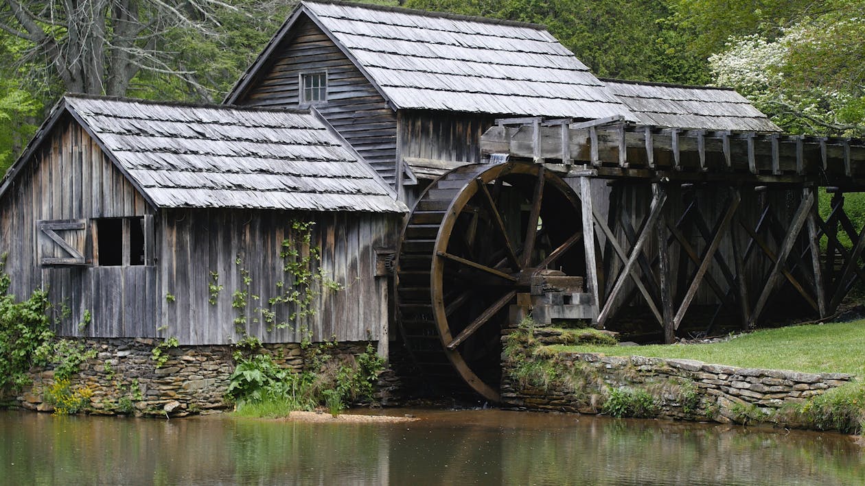 Free Gray Wooden House With Water Mill Surrounded by Trees Stock Photo