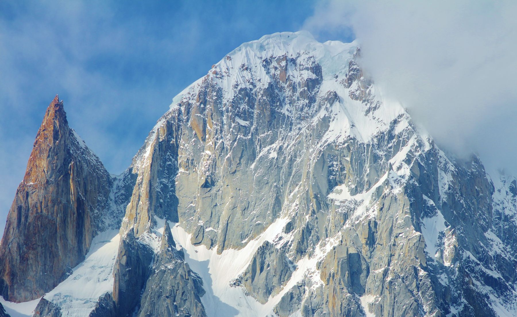 Close-up view of Ladyfinger Peak, part of Karakoram Mountains in Pakistan, under a clear blue sky.