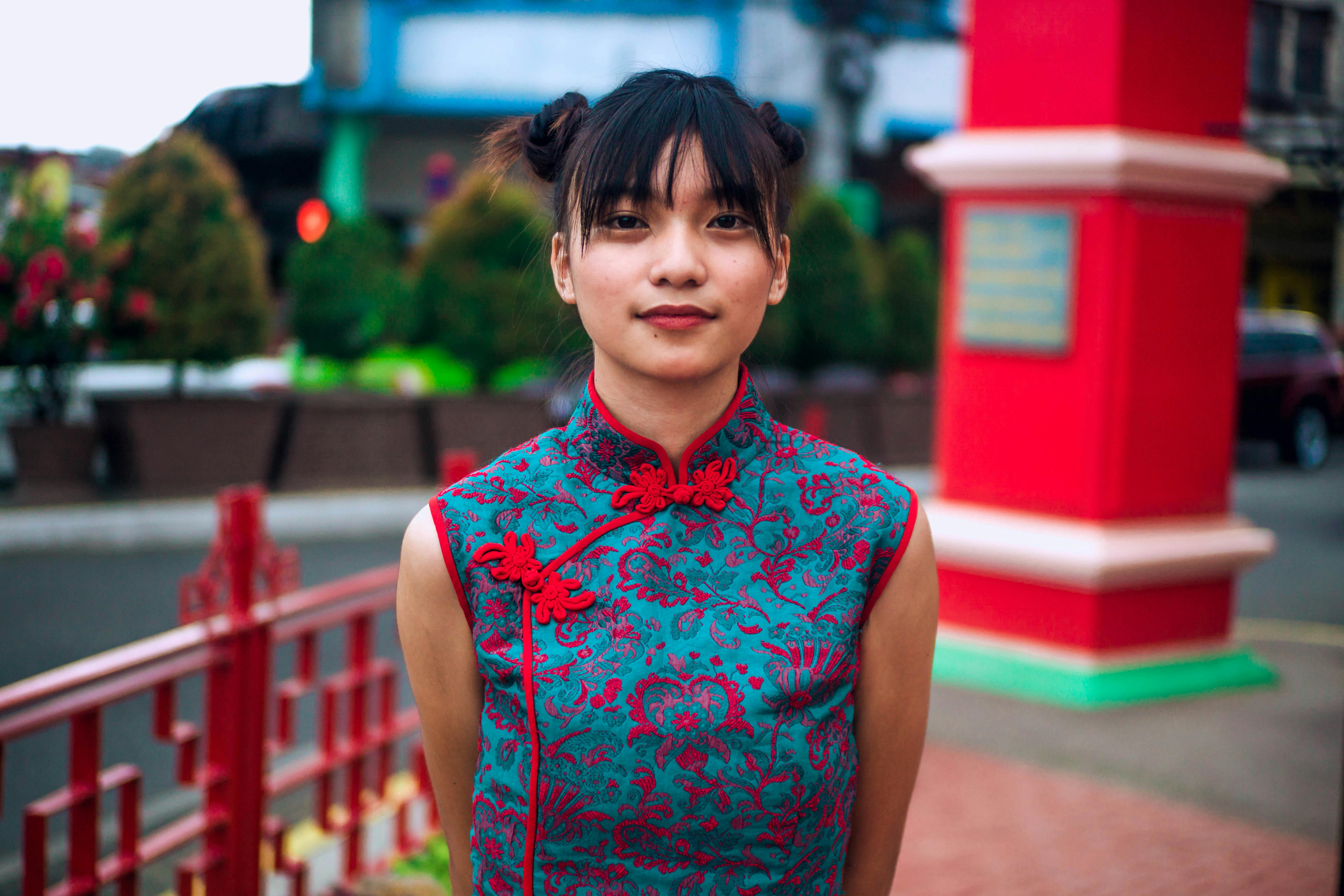 Happy young ethnic woman standing on sidewalk · Free Stock Photo