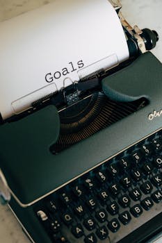 Close-up of a vintage typewriter with a paper labeled 'Goals,' emphasizing inspiration and productivity.