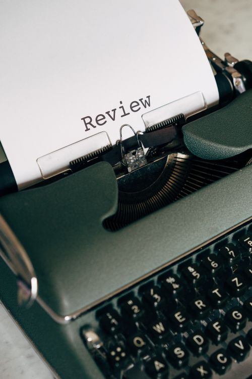 vintage typewriter typing the word Review
