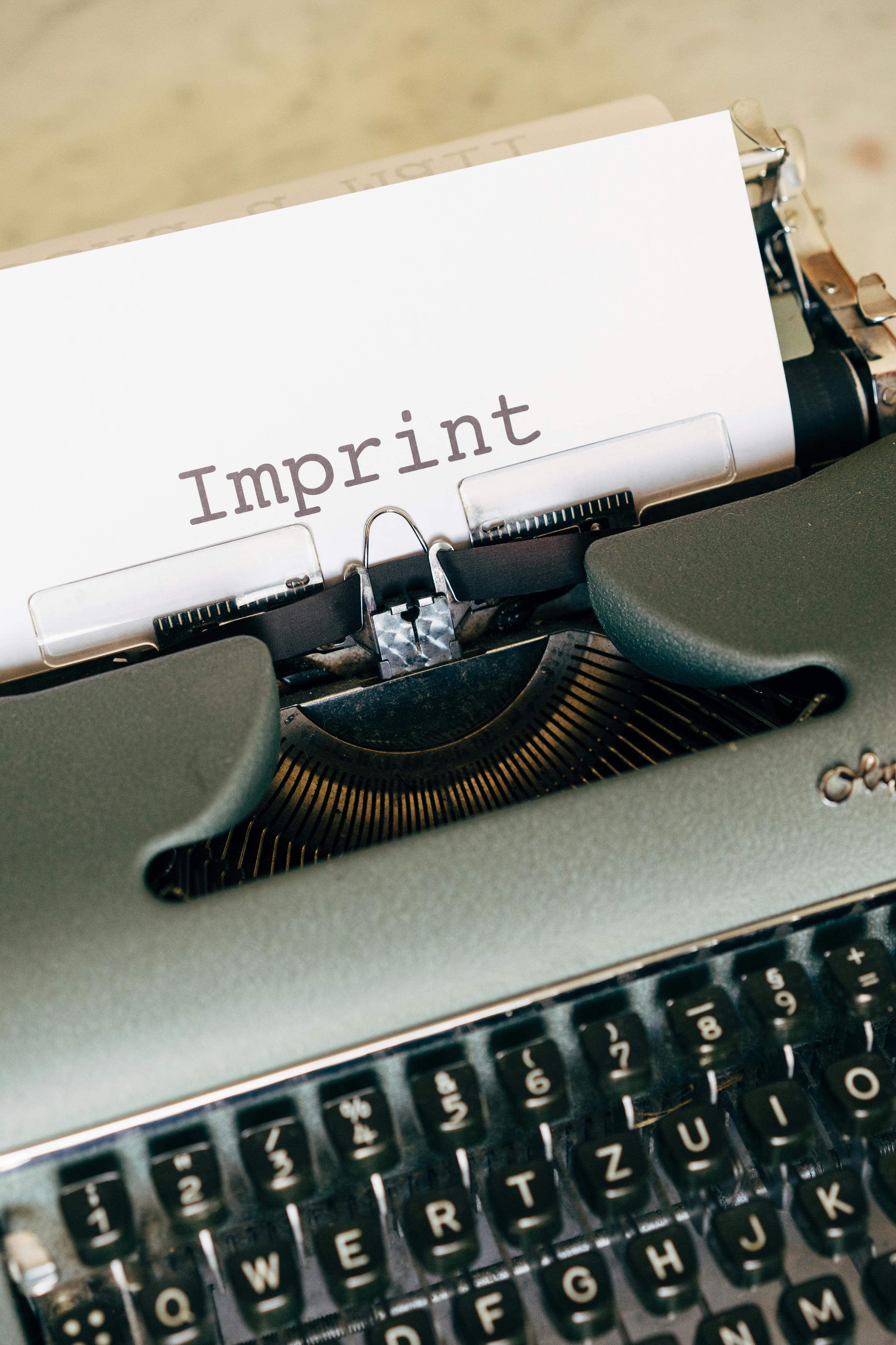 Close-up of a vintage typewriter with 'Imprint' on paper, showing retro style.