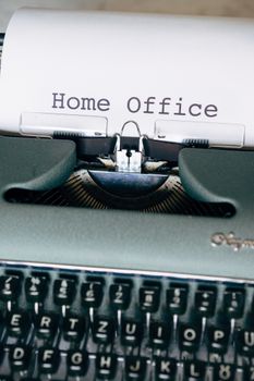 Close-up of a vintage typewriter with a paper showing 'Home Office'. Retro style.