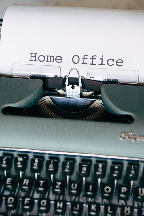 Free Close-up of a vintage typewriter with a paper showing 'Home Office'. Retro style. Stock Photo