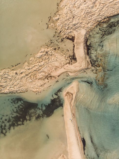 Stunning aerial view of a sandy beach and turquoise waters along Greece's coastline, ideal for travel inspiration.