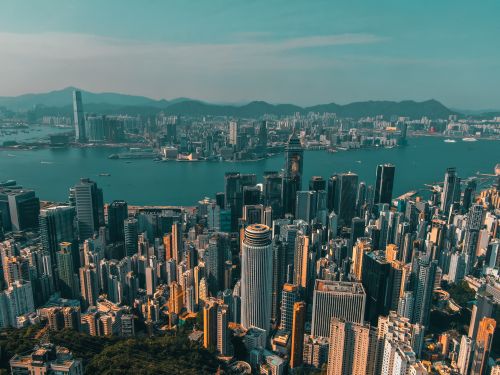Free From above of contemporary skyscrapers of modern megapolis located on shore of river against blue sky Stock Photo