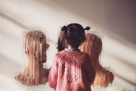 Unrecognizable kid admiring modern art paintings in museum