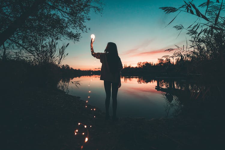 A Woman Holding A Light Bulb