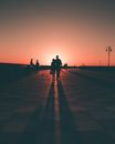 Silhouette of People Walking on Sidewalk during Sunset