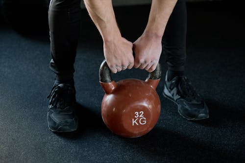 Free Person Holding Red Kettlebell Stock Photo