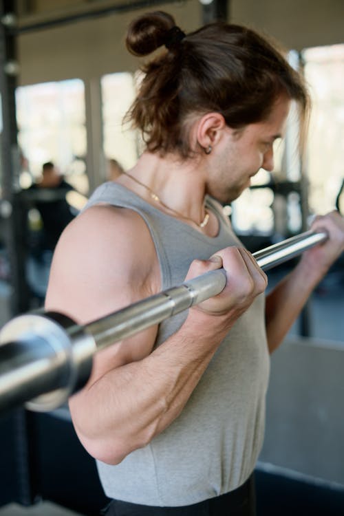 Free Man Weightlifting at the Gym Stock Photo