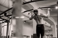 Topless Man Exercising at a Gym