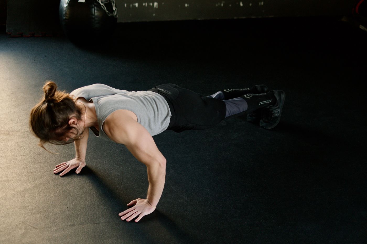 Focused athlete preparing training equipment in a minimal gym setting