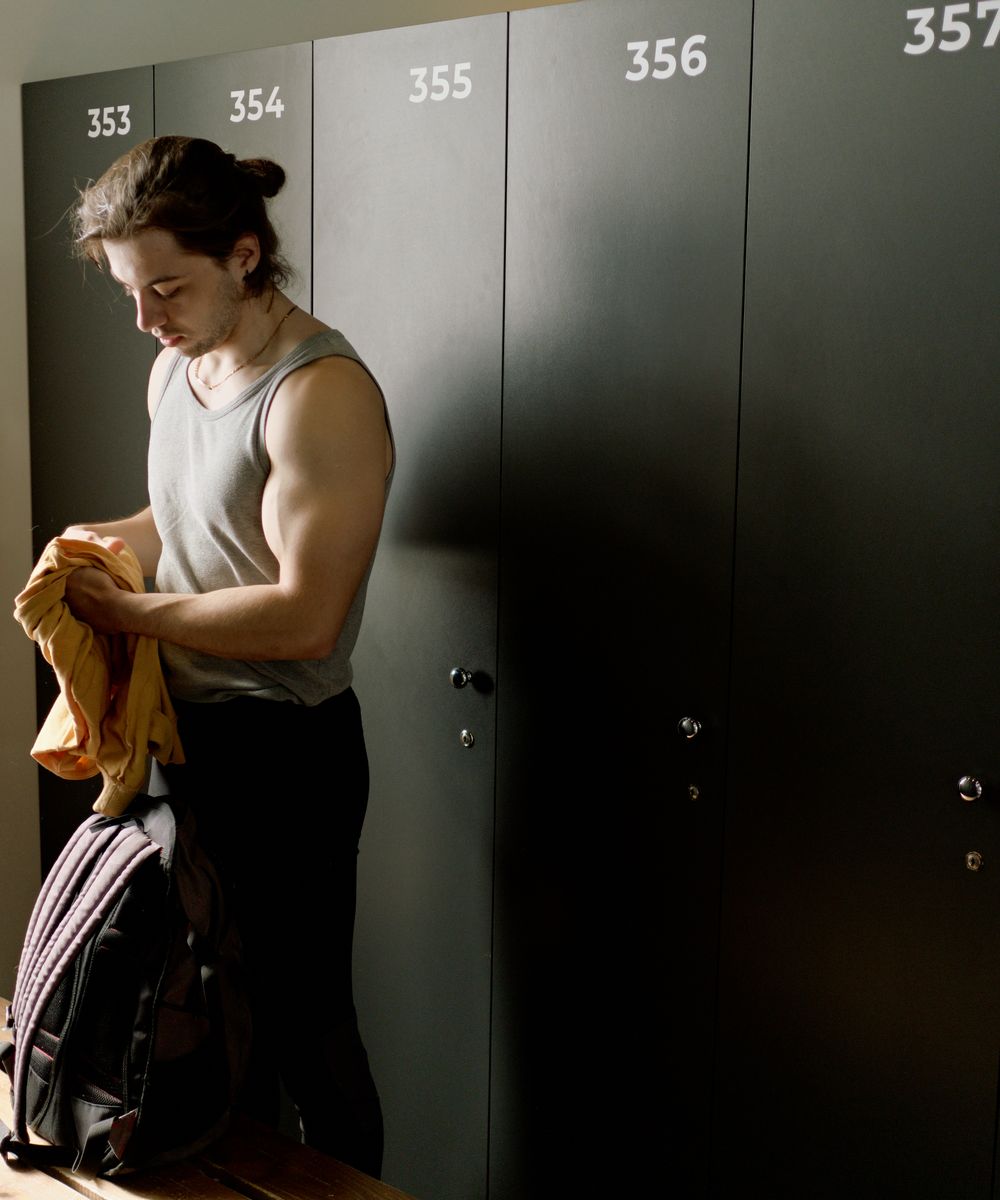 Athlete carrying a premium sports duffel bag in a locker room