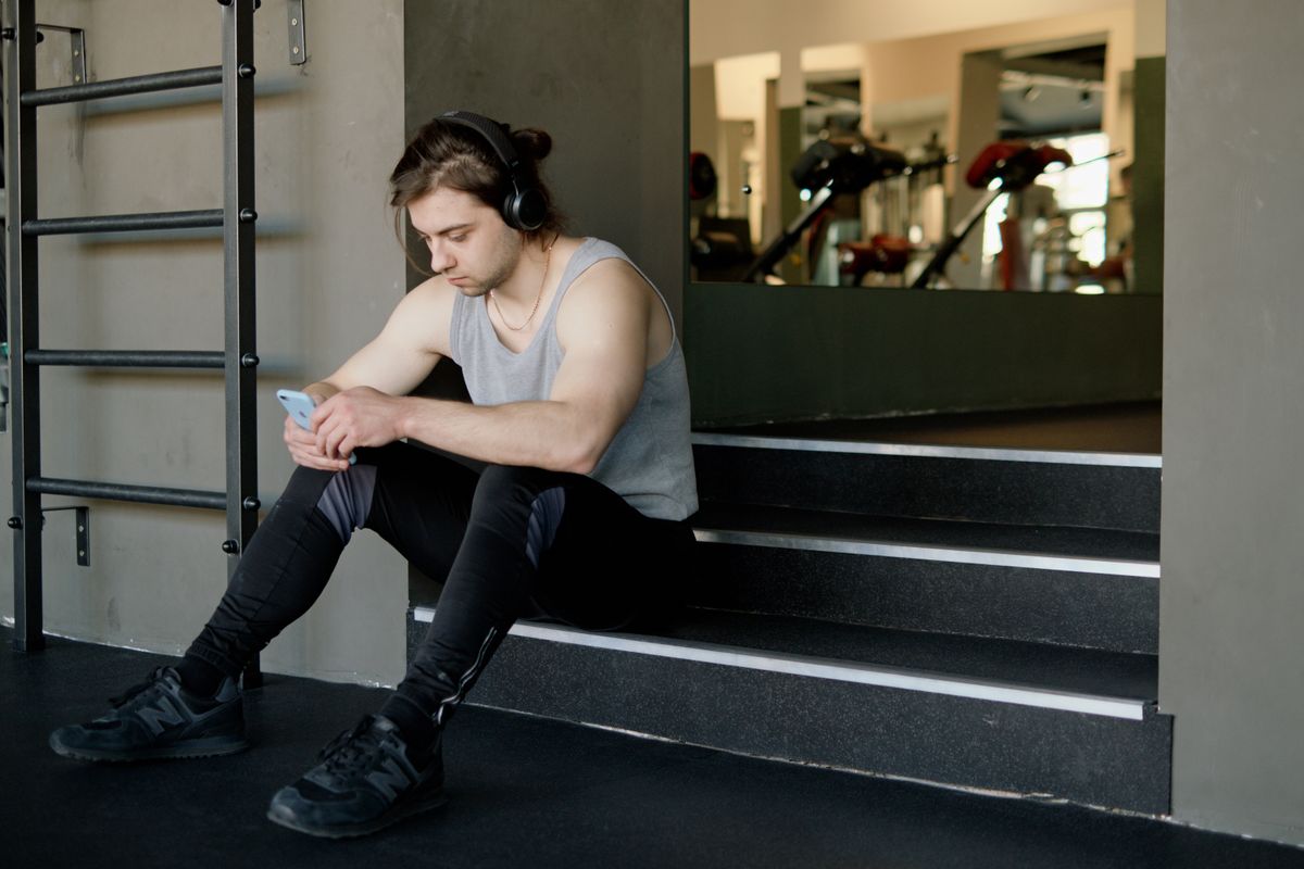 Athlete using a smartphone during a break at a fitness facility