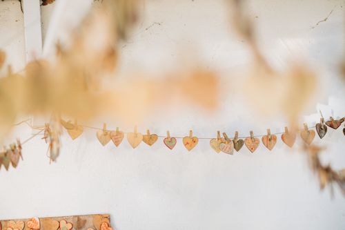 Free Hanging rope with small decorative hearts attached with clothes pegs decorating outside party Stock Photo