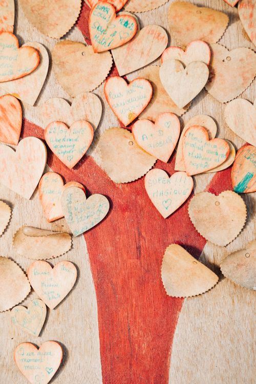 Free Top view of decorative handcrafted wooden hearts with inscriptions spilled on timber background Stock Photo