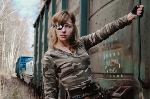 Brutal woman in eye patch hanging on train