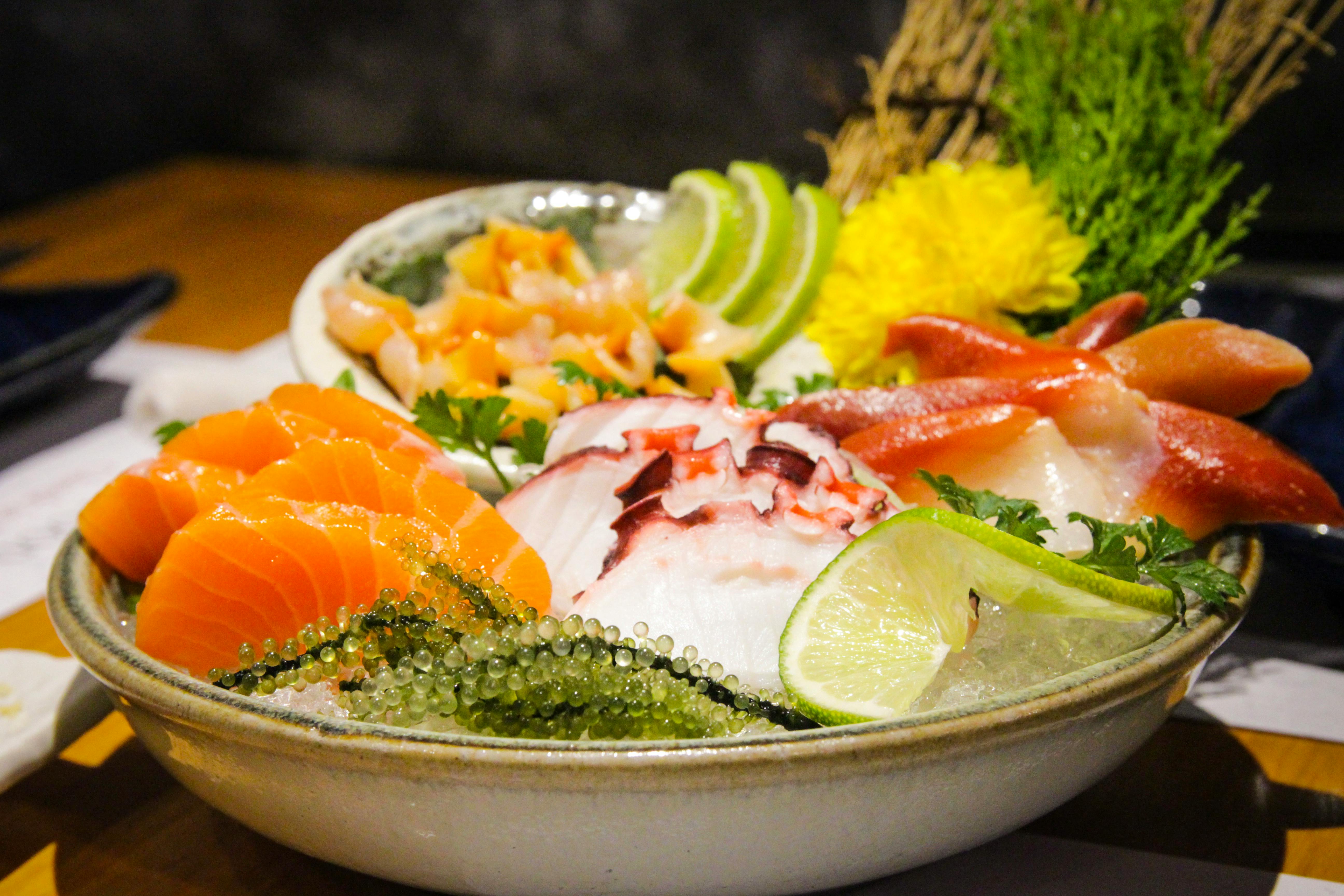 served cold sashimi with herbs and condiments