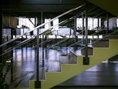 宽敞的内部设有一座现代楼梯，配有玻璃栏杆和金属设计元素