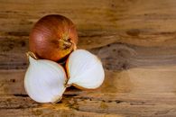 Two Garlic on Brown Wooden Table