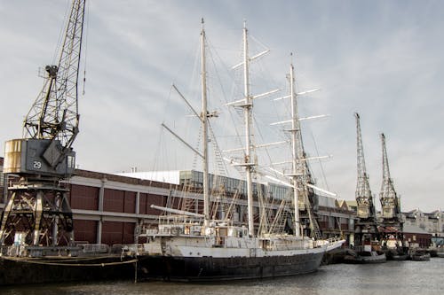 Big Sailboat and Cranes in a Dock