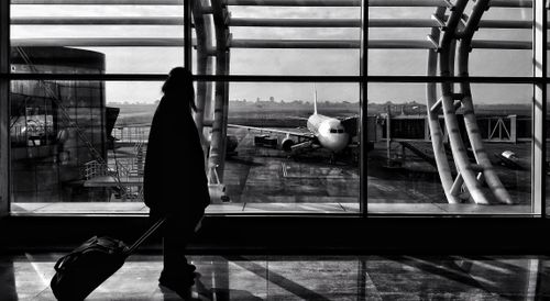 Free Silhouette of a traveler walking in Naya Raipur airport terminal, India. Stock Photo