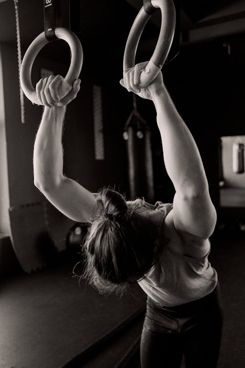 Free Grayscale Photo of a Person Holding Gymnastic Rings Stock Photo