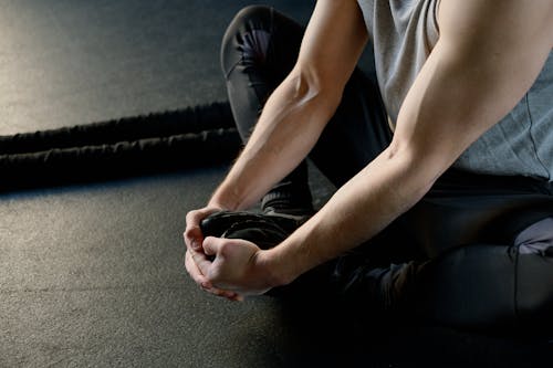 Strong Man Sitting on the Floor Stretching