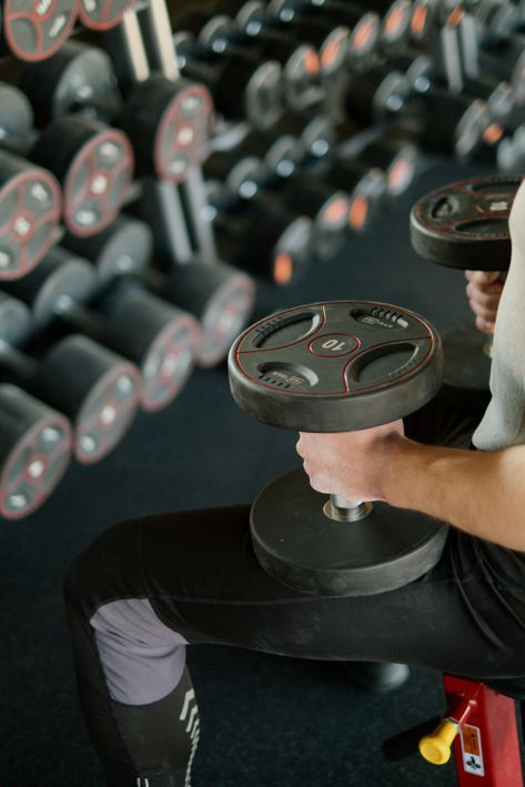 Resistance training is the most effective way to boost resting metabolic rate Person strength training with weights to build muscle and boost metabolism