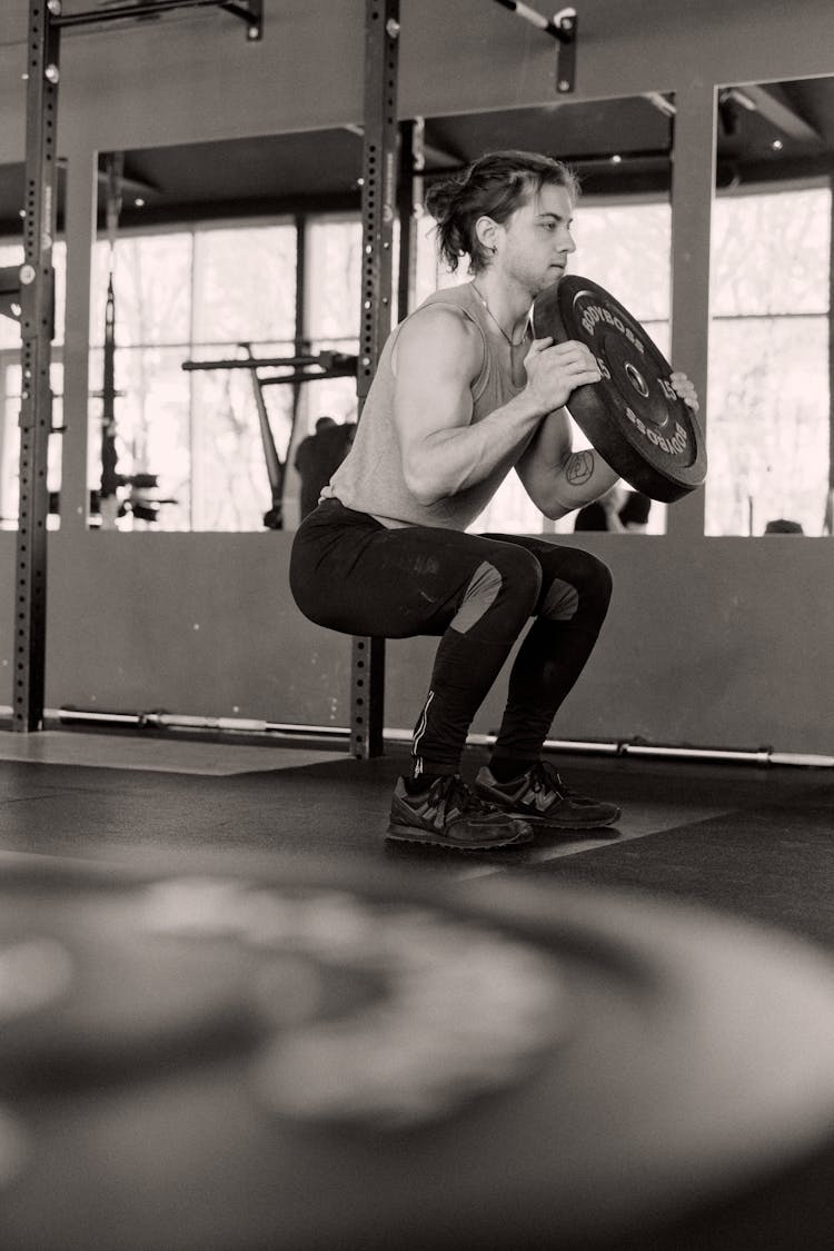 Man Doing Squats At The Gym