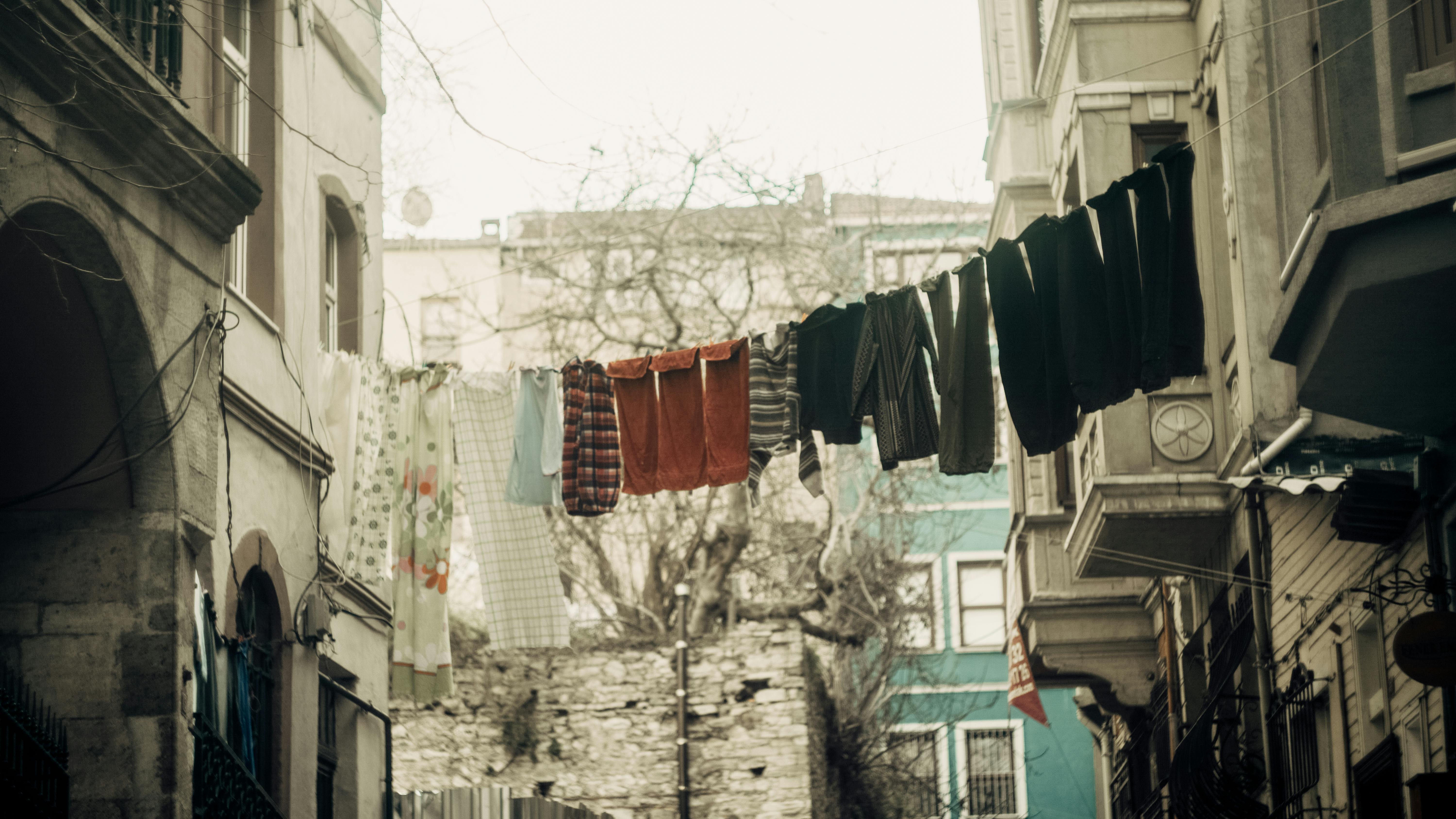 Laundry Drying on Clothesline Between Buildings · Free Stock Photo