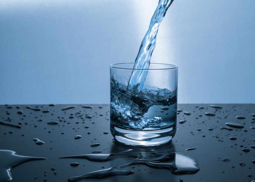 Clean water being poured into a glass — hard water affects 85% of American households
