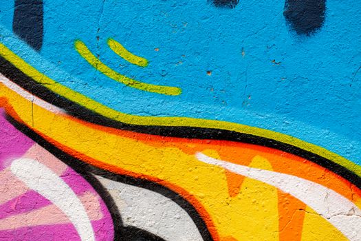 Colorful graffiti art featuring vibrant patterns on a textured wall.