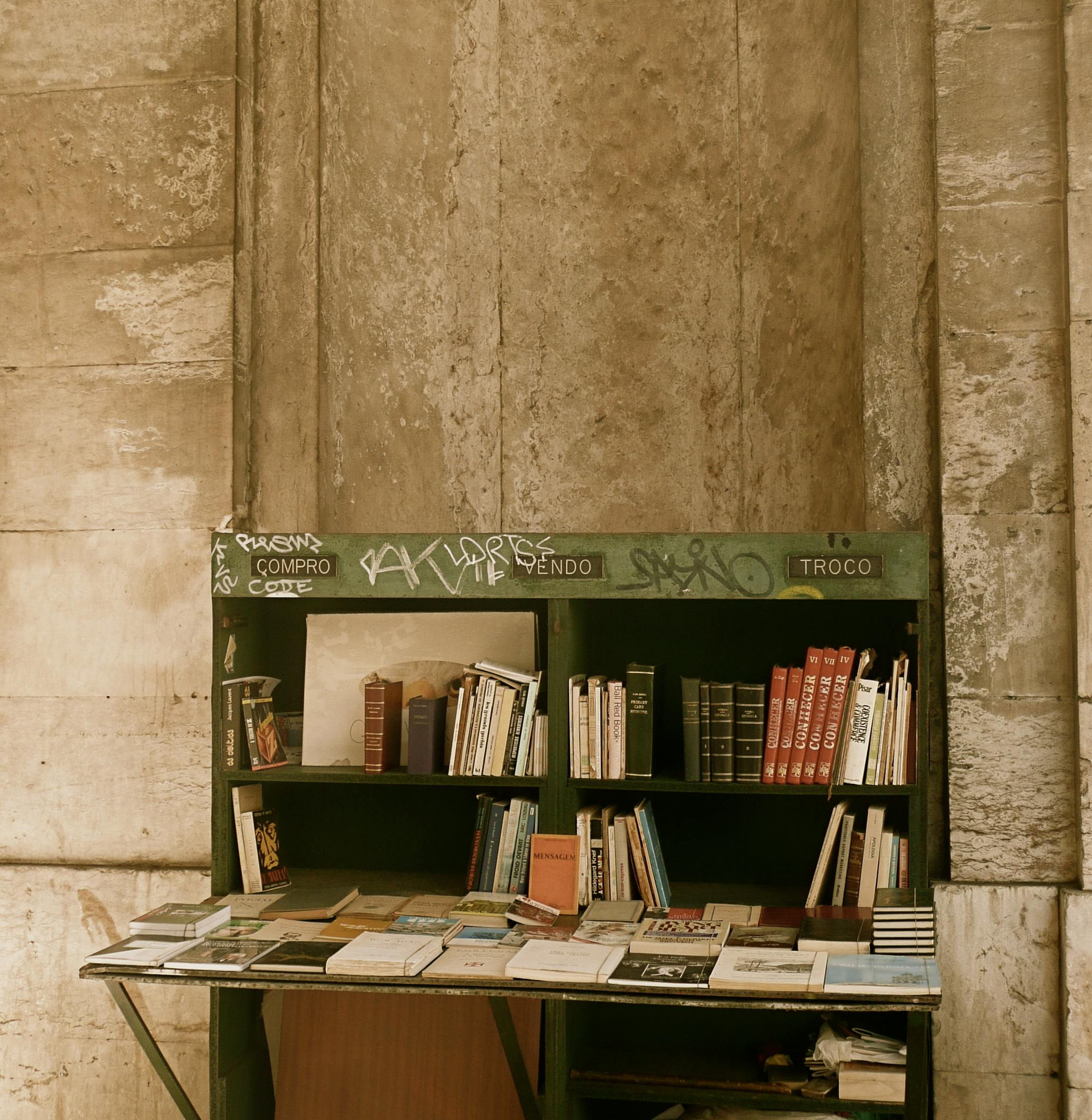 stack of books on desk on street