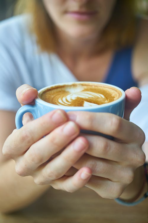 Free Person Holding Cup of Latte Stock Photo