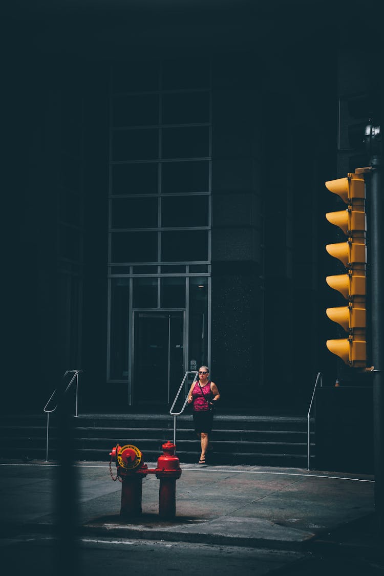 Woman In Sunglasses Leaving Building In City Street