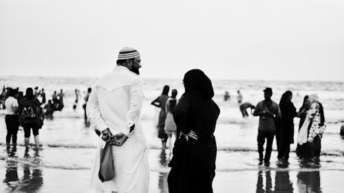 Grayscale Photo of People at the Beach