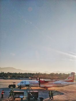 A scenic view of an airplane at Dehradun airport against a clear blue sky.