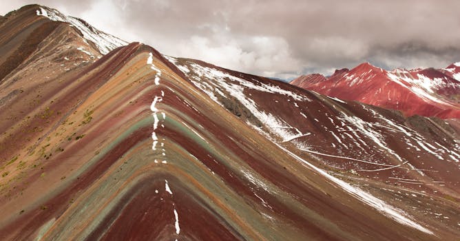 Stunning view of the vibrant Rainbow Mountain in Cusco, Peru, showcasing its vibrant colors and unique geological formations.